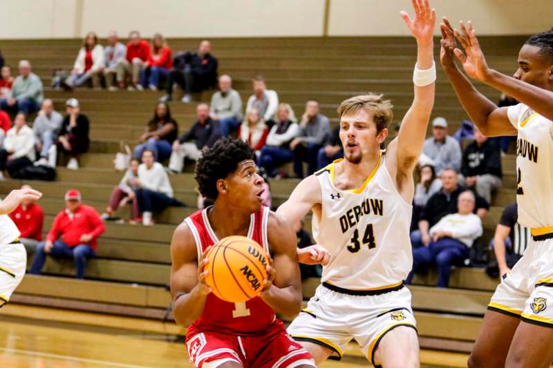 a basketball player in a red uniform playing in a basketball game