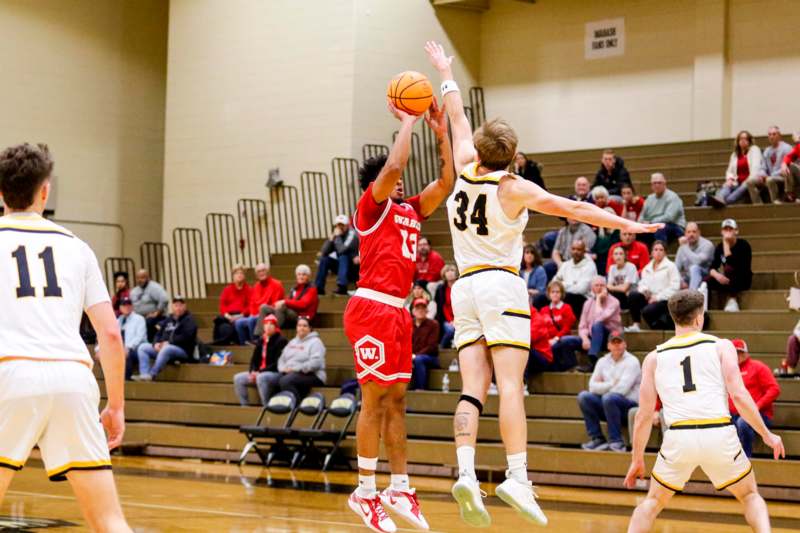 a basketball player in the air with a ball in the air