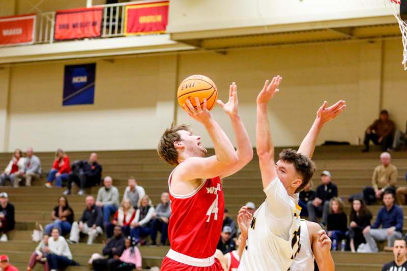 a group of men playing basketball