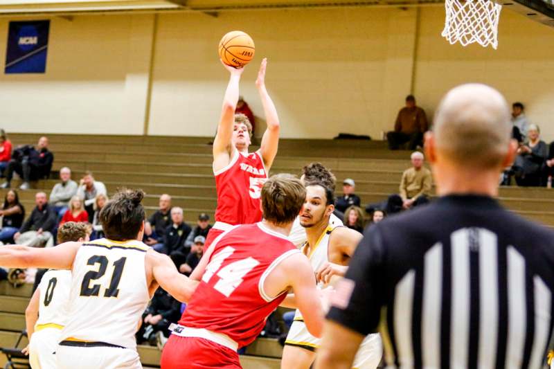 a group of people playing basketball