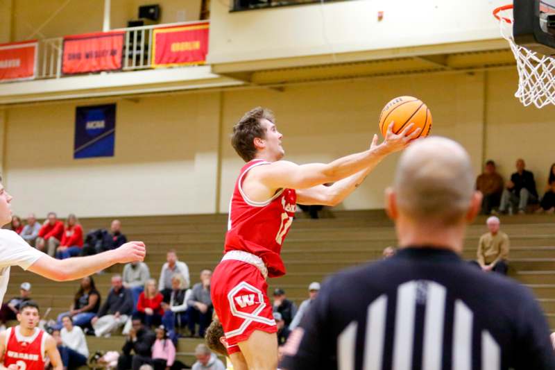 a man in a red uniform playing basketball