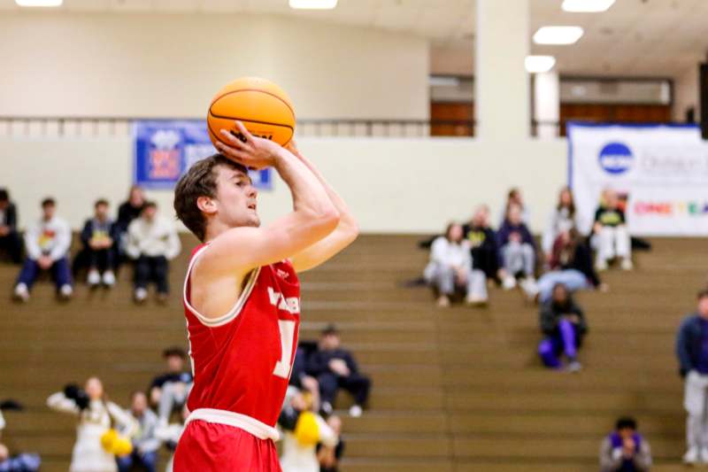 a man in a basketball uniform with a ball in his hand