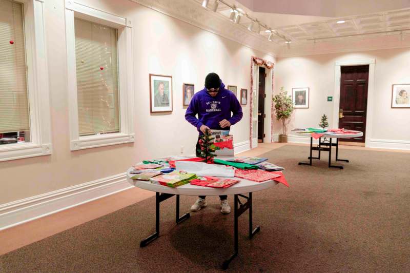 a man wrapping presents on a table