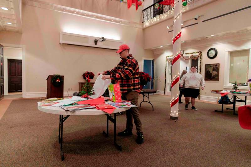 a man standing at a table with presents