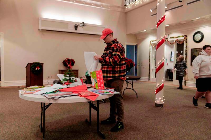 a man standing at a table with presents