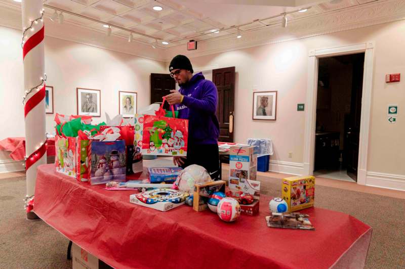 a man standing next to a table with presents