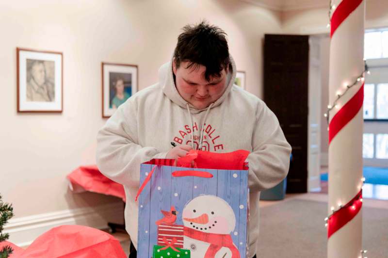 a man opening a gift bag