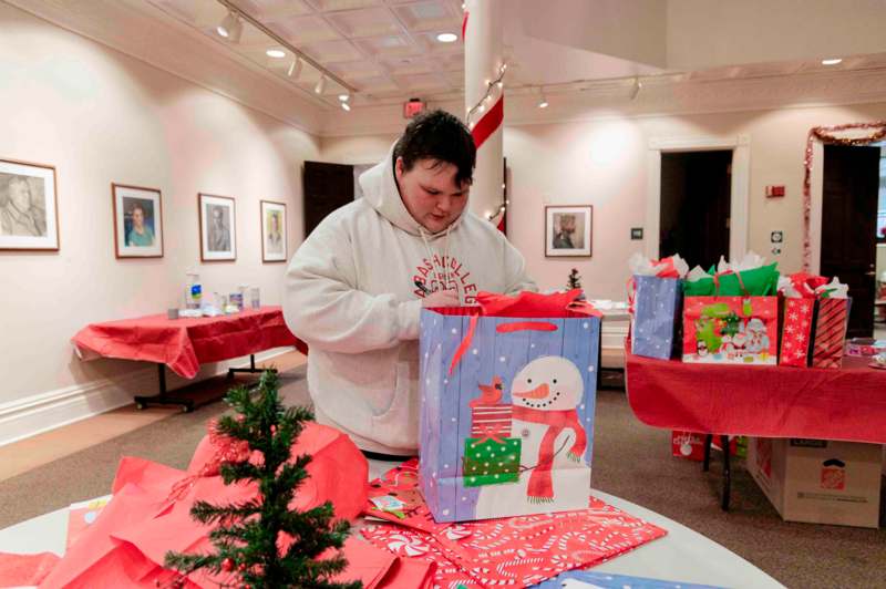 a man opening a gift bag