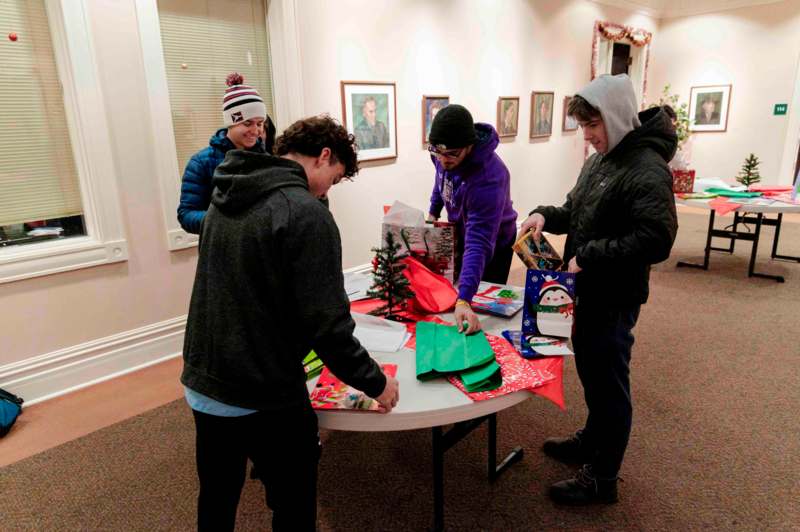 a group of people around a table with presents