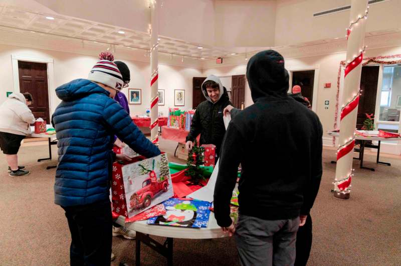 a group of people around a table with presents