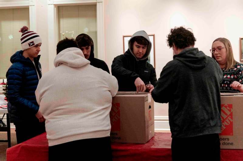 a group of people standing around a box