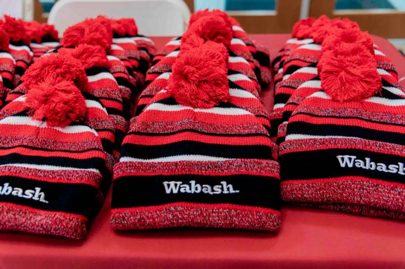 a group of red and black striped hats on a table