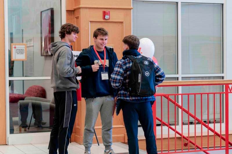 a group of men standing in a hallway