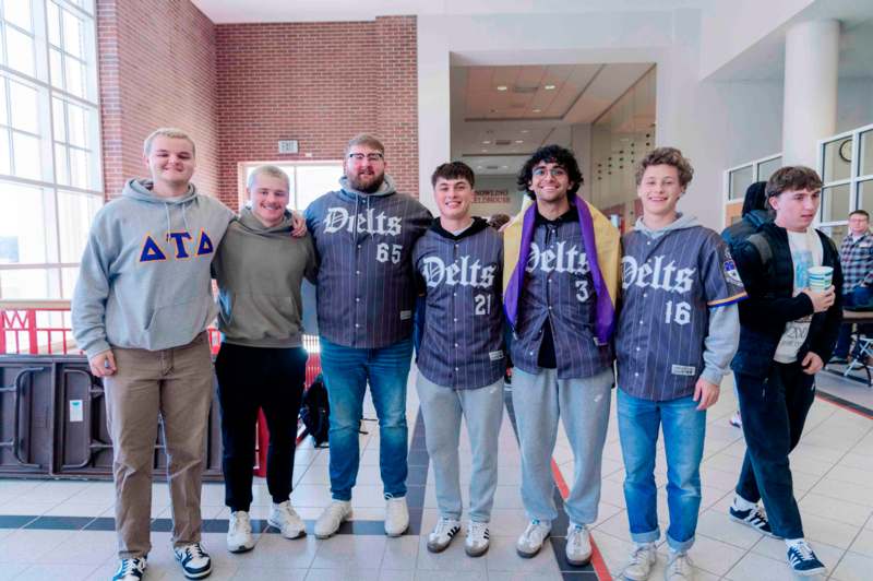 a group of men standing together in a hallway