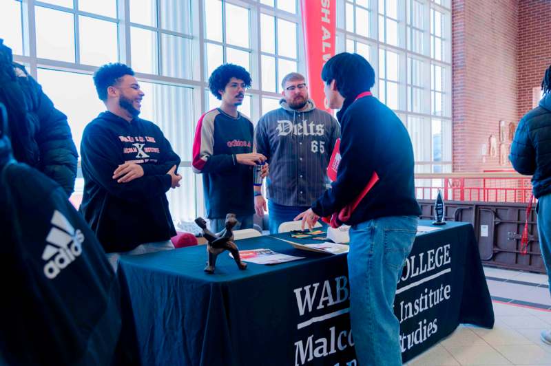 a group of people standing around a table