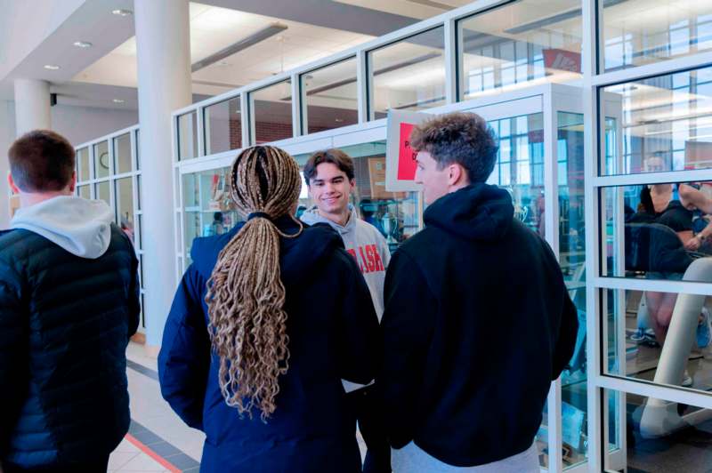 a group of people standing in a hallway