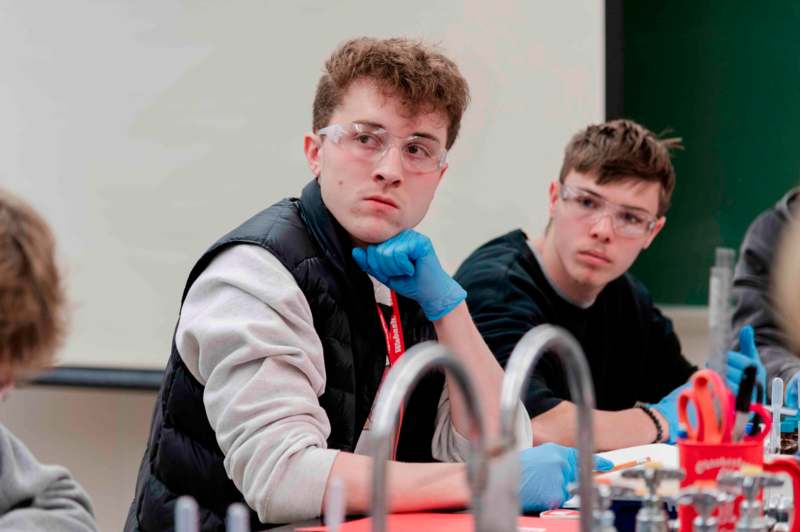 a group of men wearing safety glasses and gloves