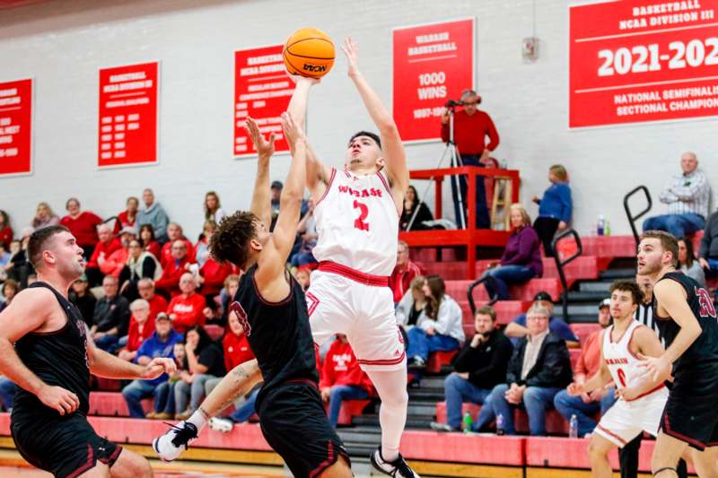 a basketball player jumping to block a basketball