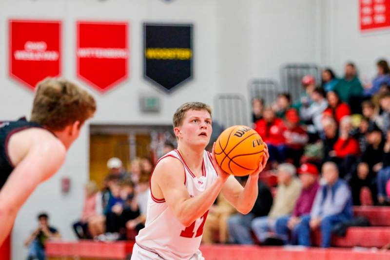 a man in a basketball uniform holding a basketball