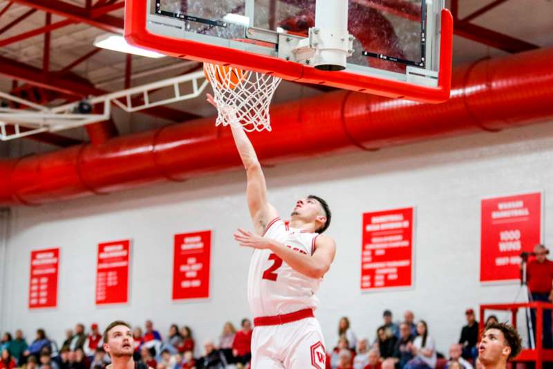 a man dunking a basketball