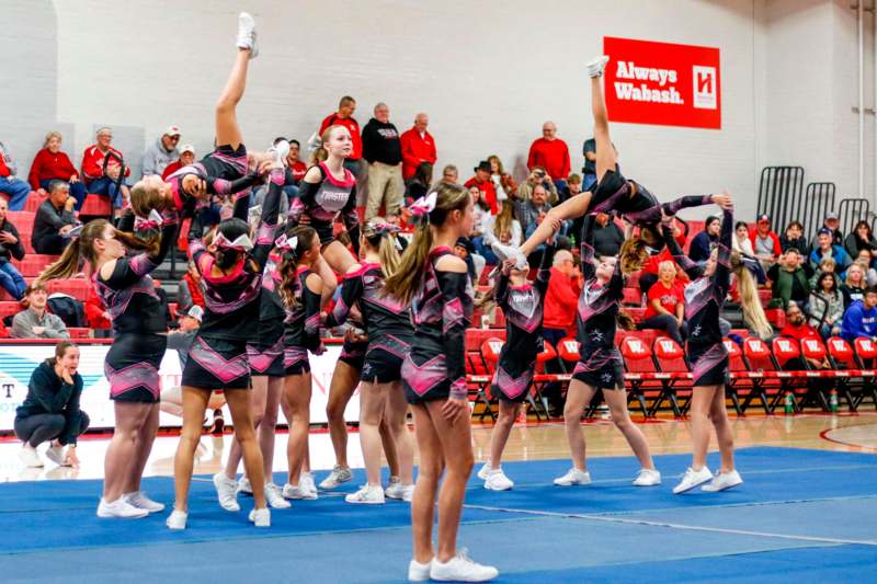 a group of cheerleaders performing a stunt