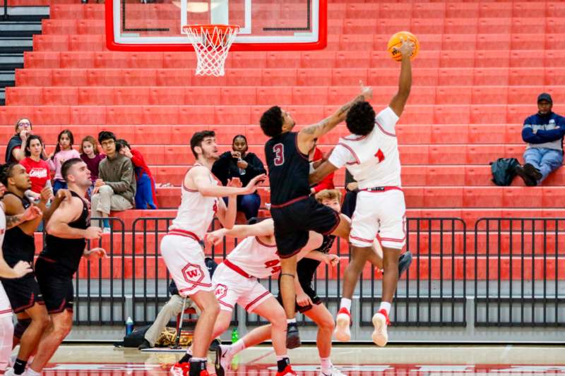 a group of men playing basketball