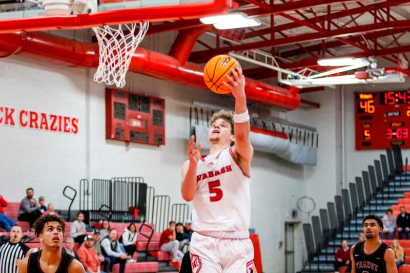 a man in a basketball uniform dunking a basketball