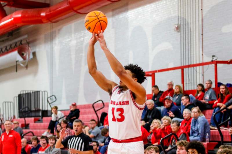 a man in a basketball uniform with a basketball in his hand