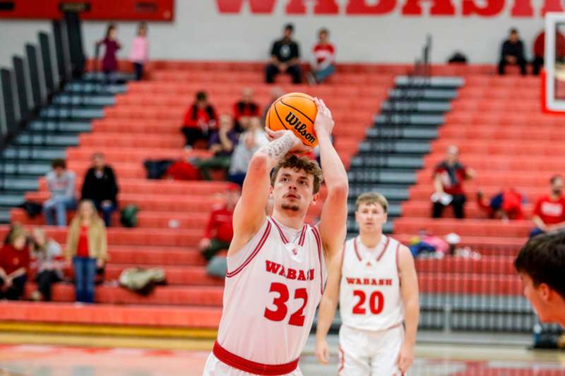 a man in a basketball uniform with a basketball in his hand