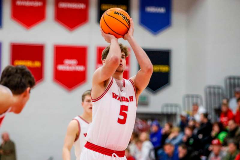 a man in a basketball uniform with a ball in his hand