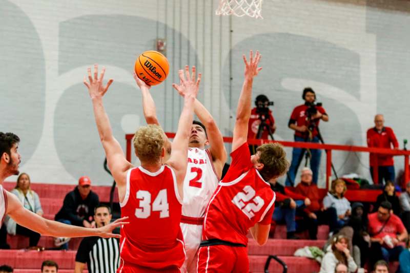 a group of men playing basketball