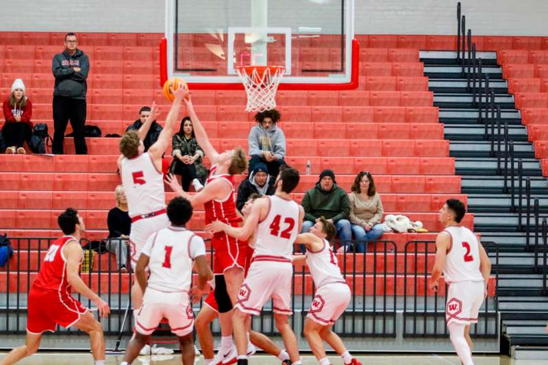 a group of people playing basketball