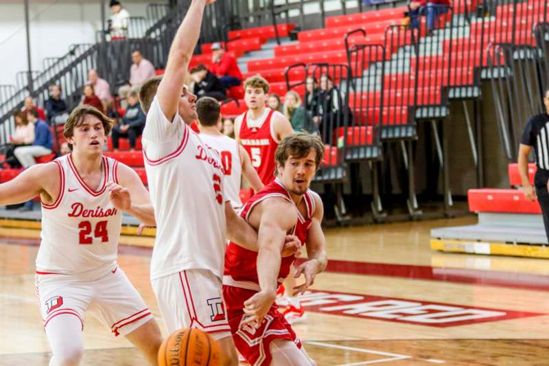 a group of men playing basketball