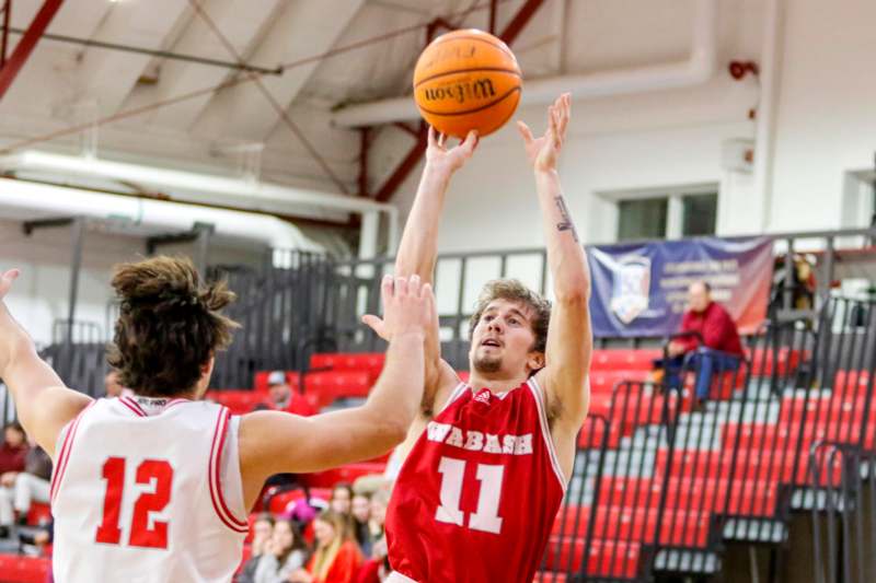 a basketball player reaching for a ball