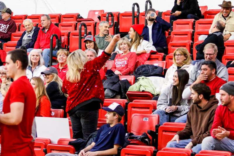 a group of people in red seats