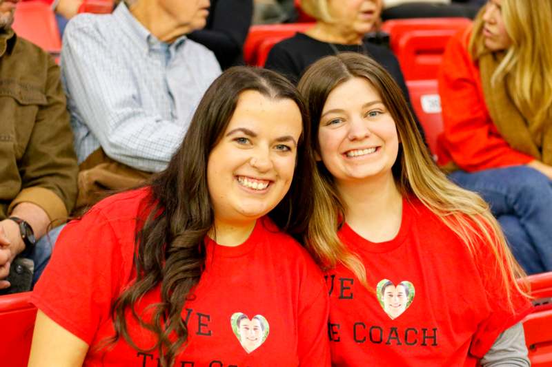 two women wearing matching red shirts