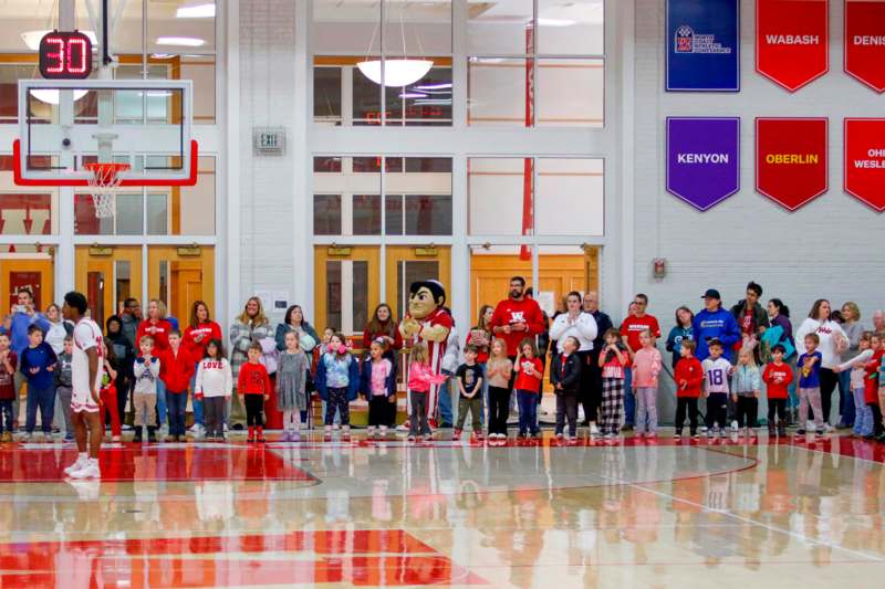 a group of people standing in a gym