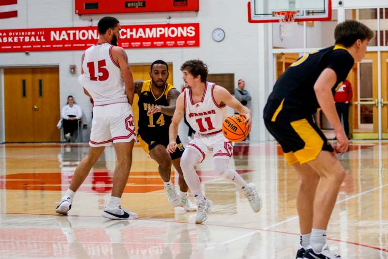 a group of men playing basketball