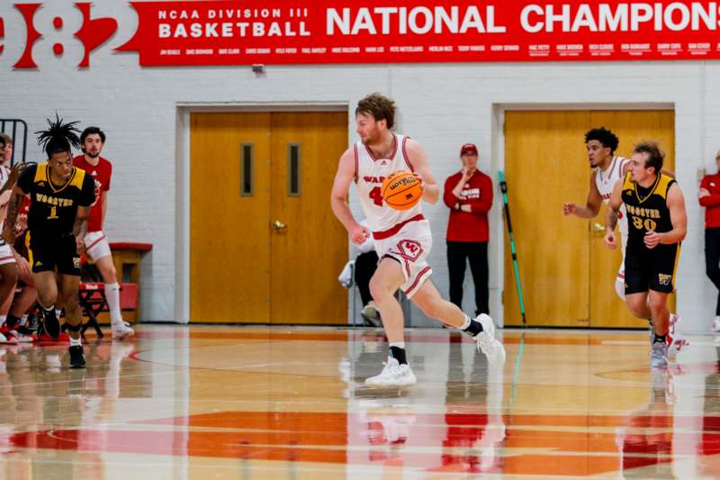 a man in a basketball uniform running with a ball