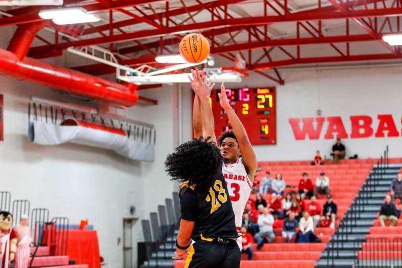 a basketball player reaching for a ball