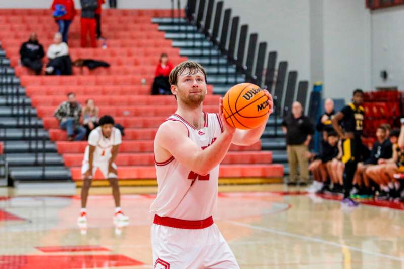 a man in a basketball uniform holding a basketball