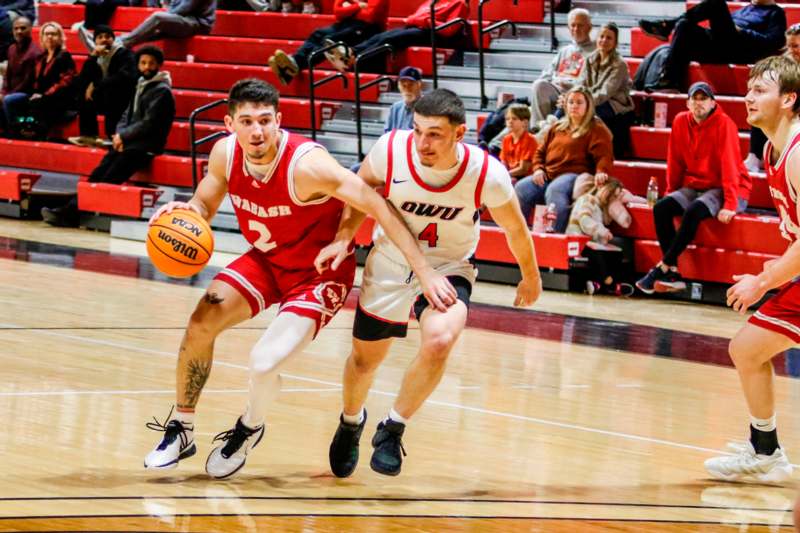 two men playing basketball in a basketball court