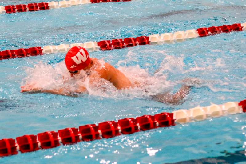 a man swimming in a pool