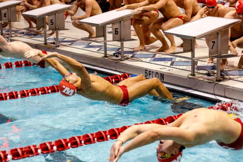 a group of people swimming in a pool