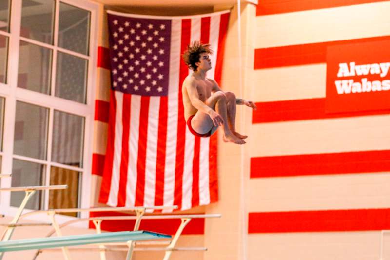 a man jumping into a pool