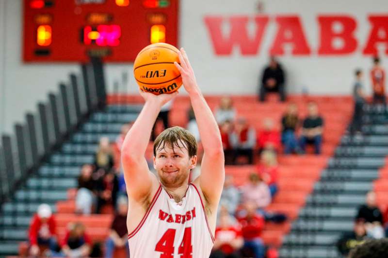 a man in a basketball uniform with a basketball in his hand