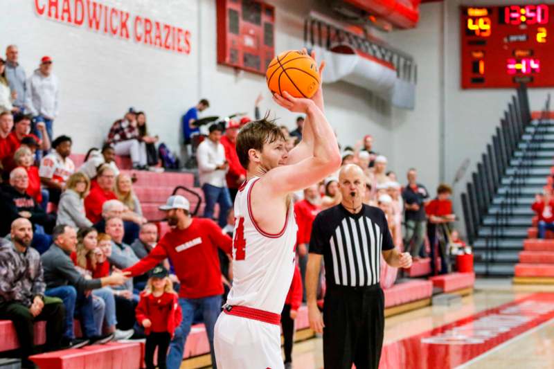 a man in a basketball uniform with a ball in his hand