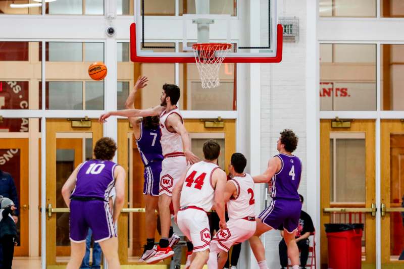 a group of men playing basketball