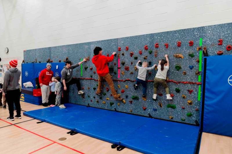 a group of people climbing a rock wall