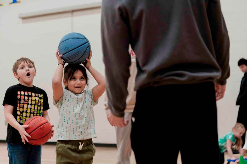 a group of kids playing basketball